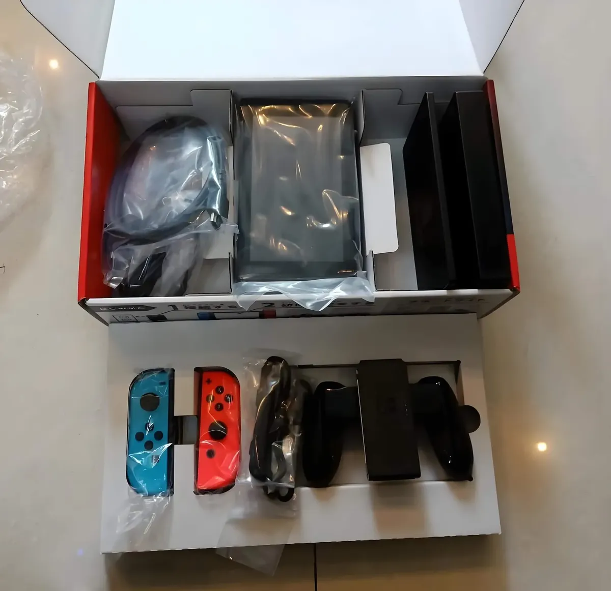 A clean, complete Nintendo Switch OLED package in its box, ready to be taken to a pawn shop.